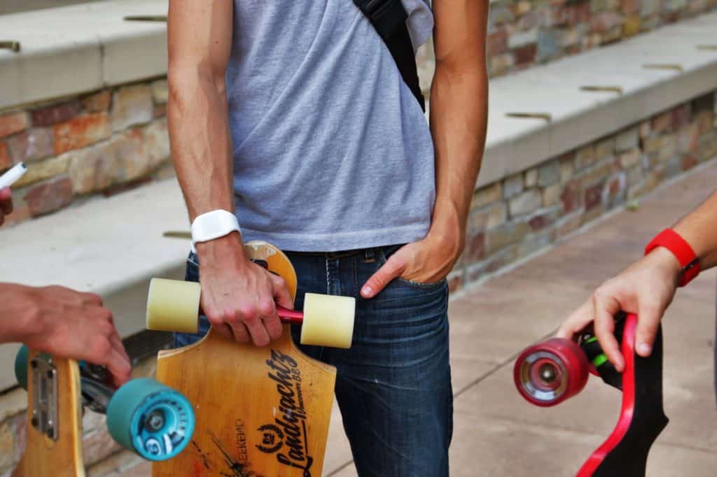 man holding his skateboard