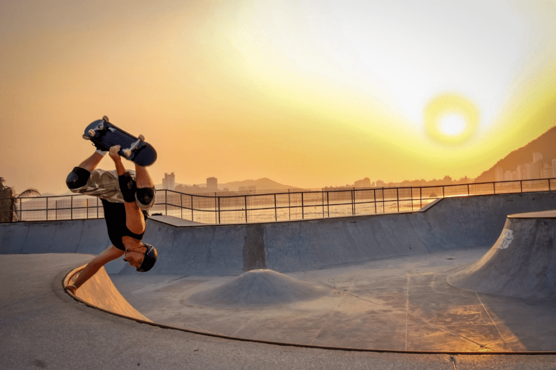 Man skateboarding using his marbel electric skateboard during sunset