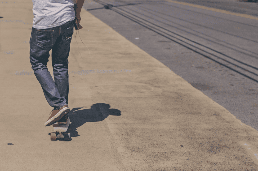 Man skateboarding using his marbel electric skateboard in the road